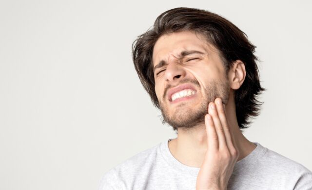 Man feeling pain in jaw. Dental health and care